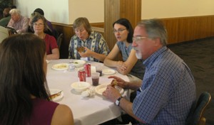 Drury breaks bread and talks meter with some poetry students .
