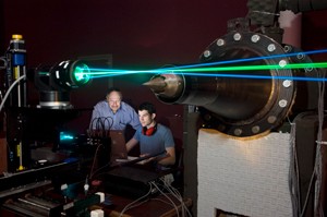 Dr. Gutmark and graduate student Chris Harris working in the lab with lasers -larynx/jet engine reasearch for aerospace engineering