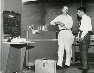 One-time UC astronomer Paul Herget, standing at left, with UC's first computer, the IBM 650.