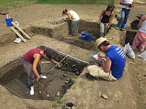 UC students Kassi Bailey (yellow shirt), Michael Crusham (blue shirt), and Kathleen Forste (red shirt) at work on the excavation. 
