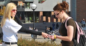 A UC advisor hands out information on McMicken Commons.