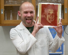 UC's Zachary Copfer mimics his bacteriography image, made of e-coli, of Albert Einstein.