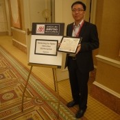 Xin Wang at the AMA Conference with the Best Paper Award.