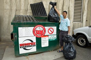 Recycling at Calhoun Residence Hall. Desk staff and Grad student in Computer Eng, Vishnu Suresh disposes of recyclables from two floors.