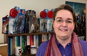 Associate Professor Rebecca Borah, PhD shown here in her office with her collection of female superheroes action figures at McMicken Hall. 