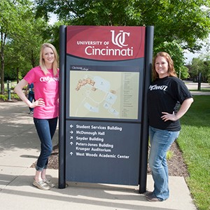 Students standing near sign on campus
