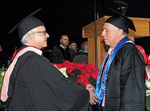 Jonatham Newmark shakes the hand of Dean Peter Landgren, dean of the UC College-Conservancy of Music.