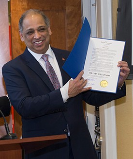 Image of President Pinto Receiving Governor's Resolution