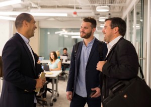 Former UC student Andrew DeZarn, center, co-founded consulting company Vooru in 2015 with business partner Matt Sutton, right. 