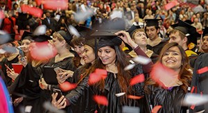 Graduates celebrate amid confetti at the December 2016 Commencement ceremony.