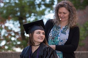 UC graduate and Batavia resident Tori Thomas and her mom, Melissa Caldwell, enjoy a long-awaited moment at the University of Cincinnati following an arduous climb to finish her degree. 