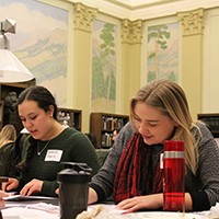 Several female engineering students are taking notes during the event.