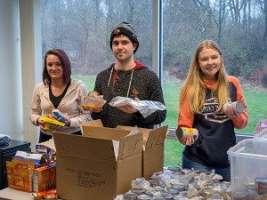 UC Clermont students (from left) Jeri Gibson, Todd Whoberry and Kayla Weisbrodt pack To-Go Bags for the Clermont Bearcats Food Pantry. 