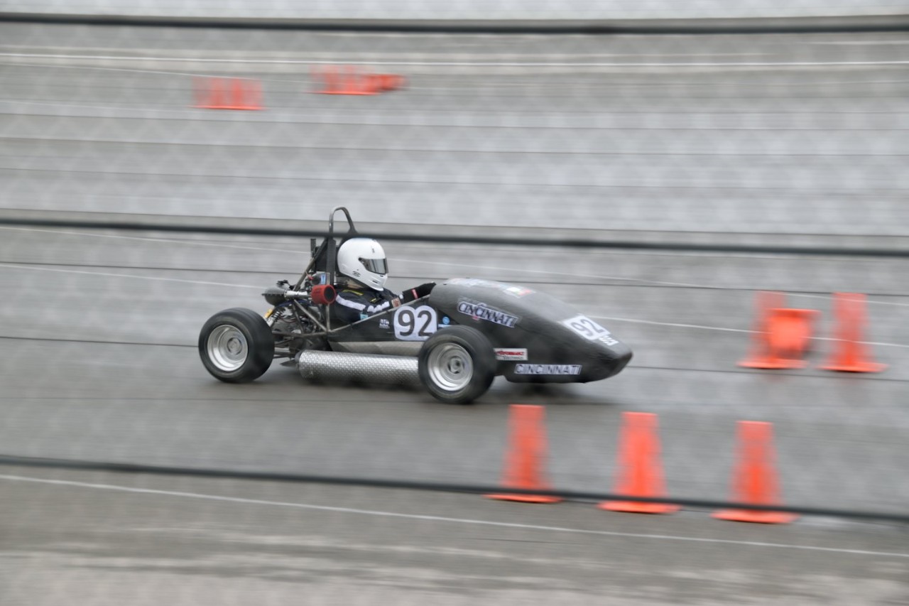 student driving car on racetrack