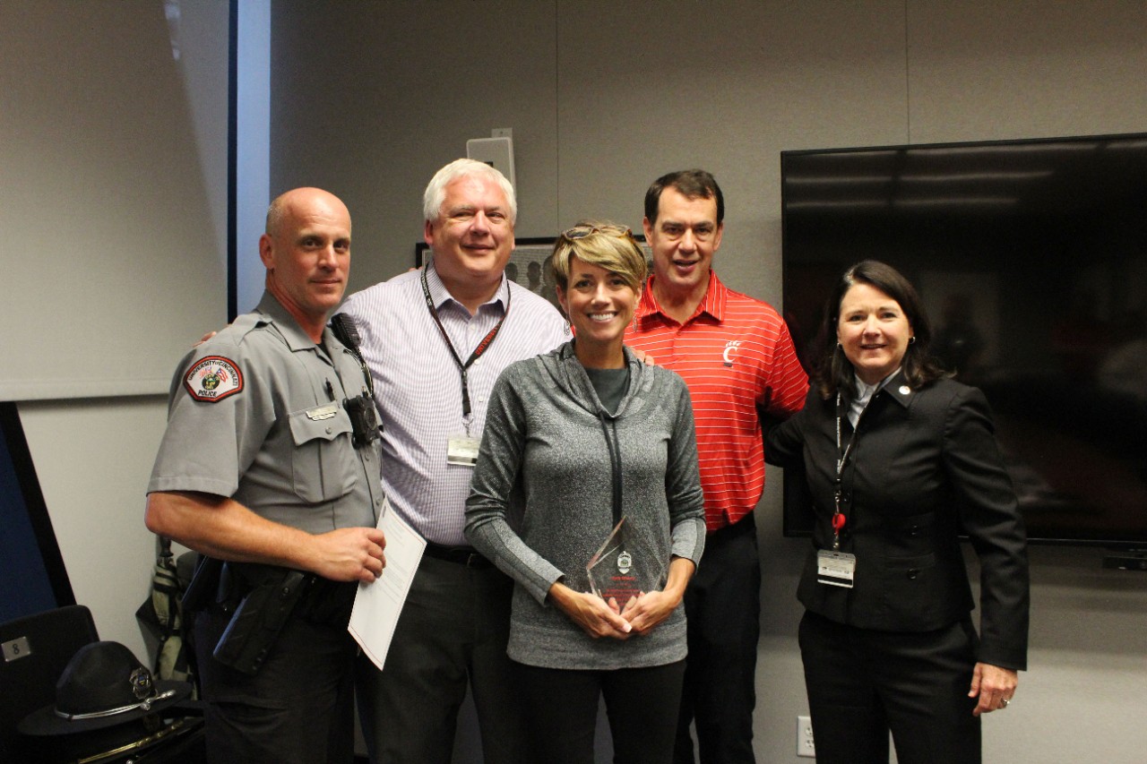 From left, Officer Kevin Ellison, Public Safety Director James Whalen, Athletics Associate Beth Hussey, Athletics Director Mike Bohn and UC Police Chief Maris Herold pose for a photo after Hussey received the annual Police Community Collaboration Award.