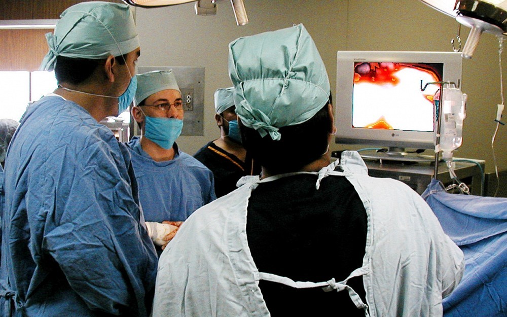 Mark Thomas, MD, (center) and his team perform a laparoscopic pediatric liver resection in Mexico.