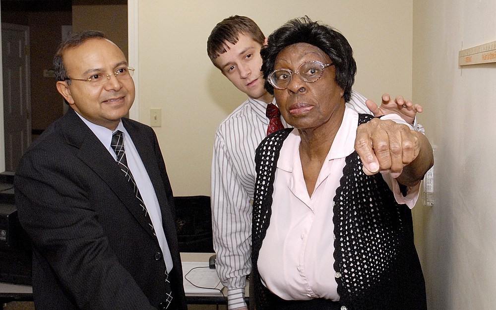 Arvind Modawal, MD, and medical student Robert Altenau, give the functional reach test to patient Sue Thomas. 