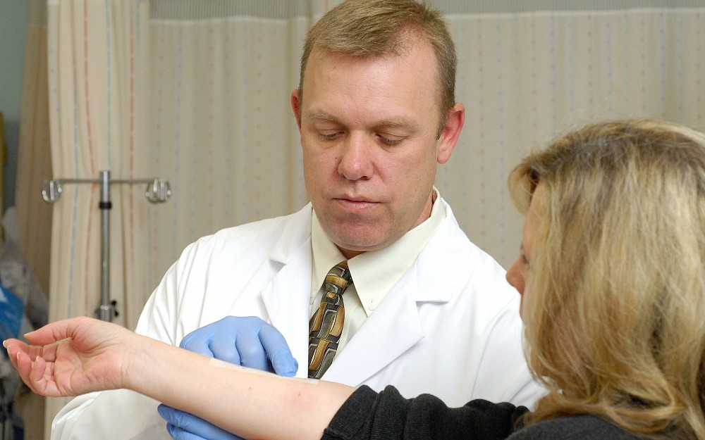 Joseph Moellman, MD, in the emergency department at University Hospital performing a skin test for penicillin allergy 