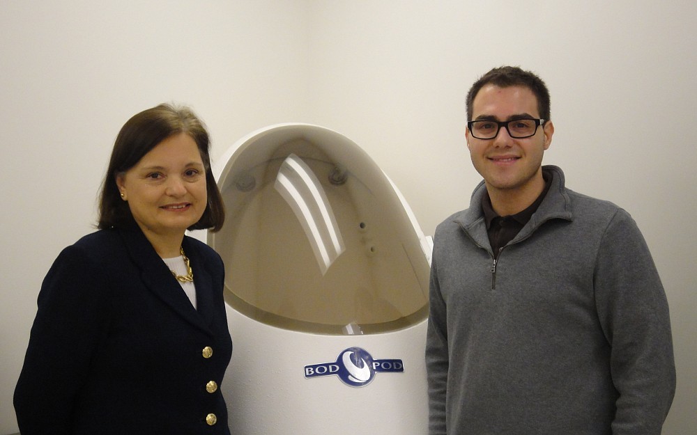 Nutritional Sciences Chair Grace Falciglia, PhD, and Loren Brook, the first student in the new dual MD/MS in nutrition degree program, with the "Bod Pod" in the nutritional sciences lab at the College of Allied Health Sciences