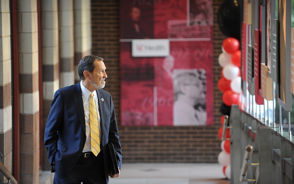 Thomas Boat, MD, College of Medicine dean, views University Hospital's new permanent lobby exhibit highlighting the hospital's long history and leadership in innovation.