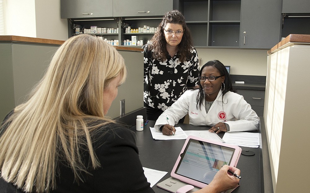 Shauna Buring, PharmD, (center) in the Pharmacy Practice Skills Center, James L. Winkle College of Pharmacy. The Center will use iPads and other technology to provide immediate feedback to students.