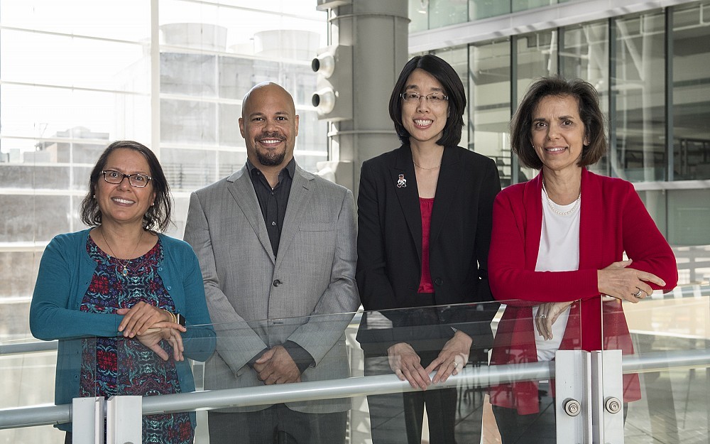 A group of College of Medicine career advisors is shown in CARE/Crawley Building. From left to right: Gurjit Khurana Hershey, MD, Christopher Lewis, MD, Alice Mills, MD, and Aurora Bennett, MD.