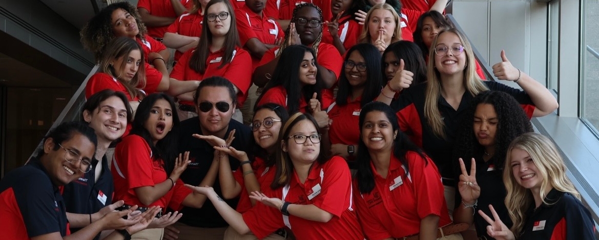 Student Orientation Leaders wearing uniforms, doing silly poses