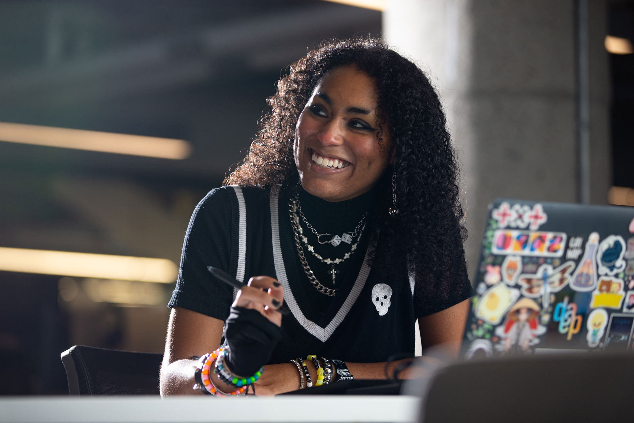 A University of Cincinnati student works on her laptop in the 1819 Innovation Hub